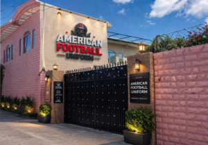 Industrial factory floor of American Football Uniforms featuring advanced stitching lines and custom apparel production zones.