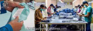 Quality control specialist at American Football Uniforms performing final inspection on custom jerseys for seam integrity.