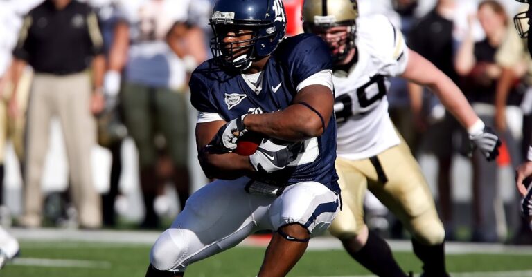 Intense moment captured during an American football game showcasing players in full action on the field.