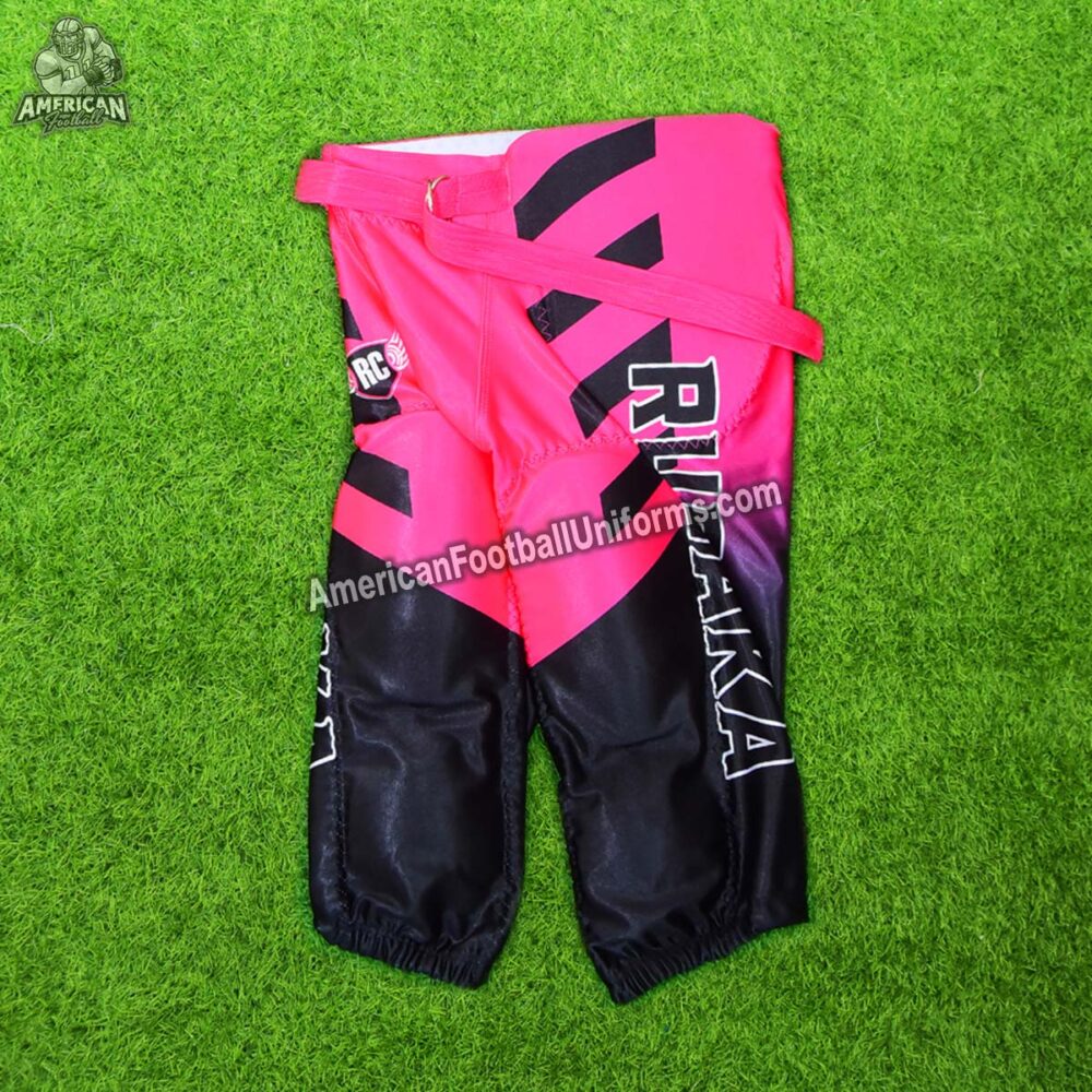 Side view of American Football Uniforms hot pink football pants featuring integrated pad pockets and reinforced stitching.