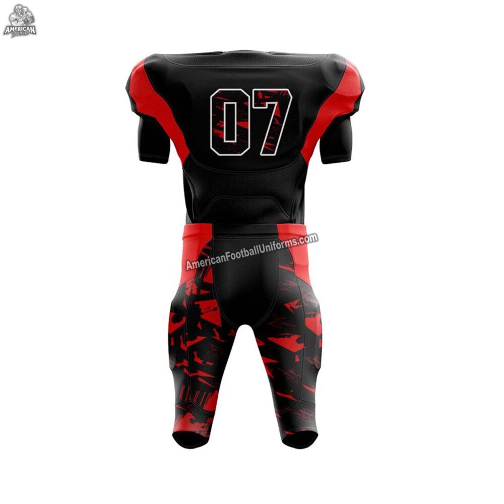 Full view of a custom red and black American football uniform including matching pants with reinforced side piping and belt.
